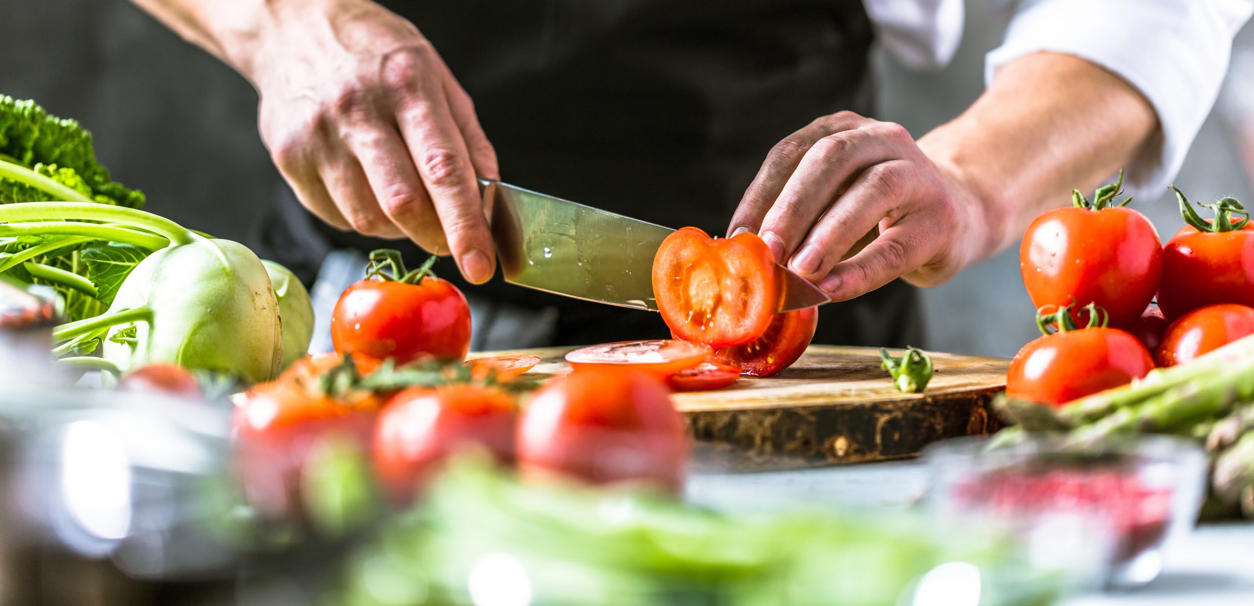 Chefkoch in der Küche mit Frischem Gemüse(Tomaten)